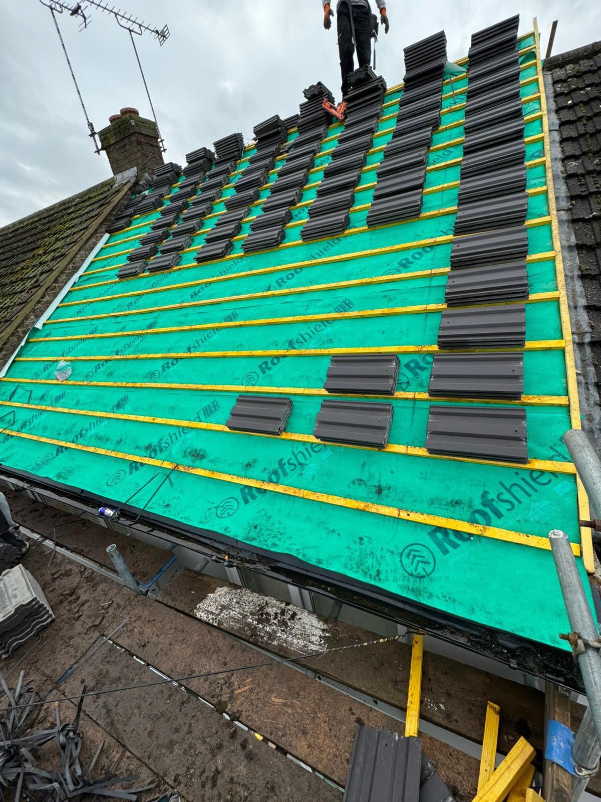 Roof re-covering in progress with breathable membrane and timber battens