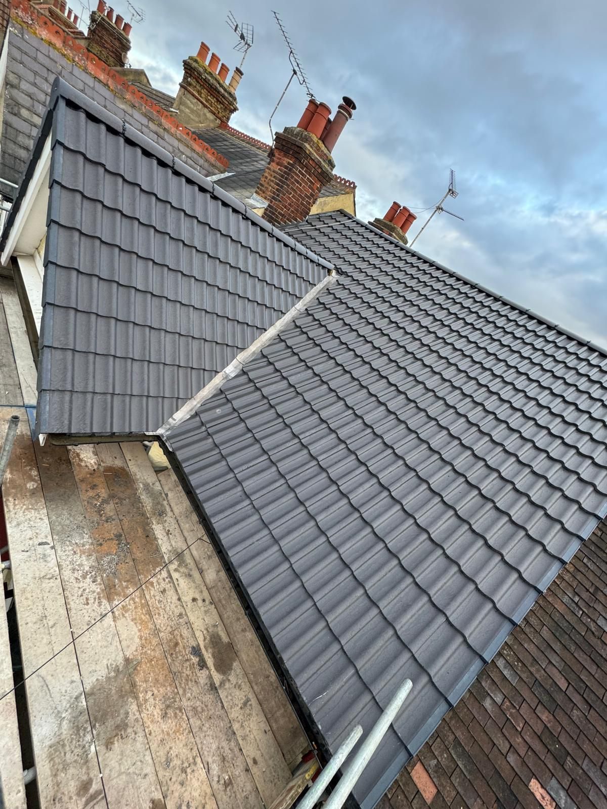 New roof tiles with bedded ridge tiles running down the slope