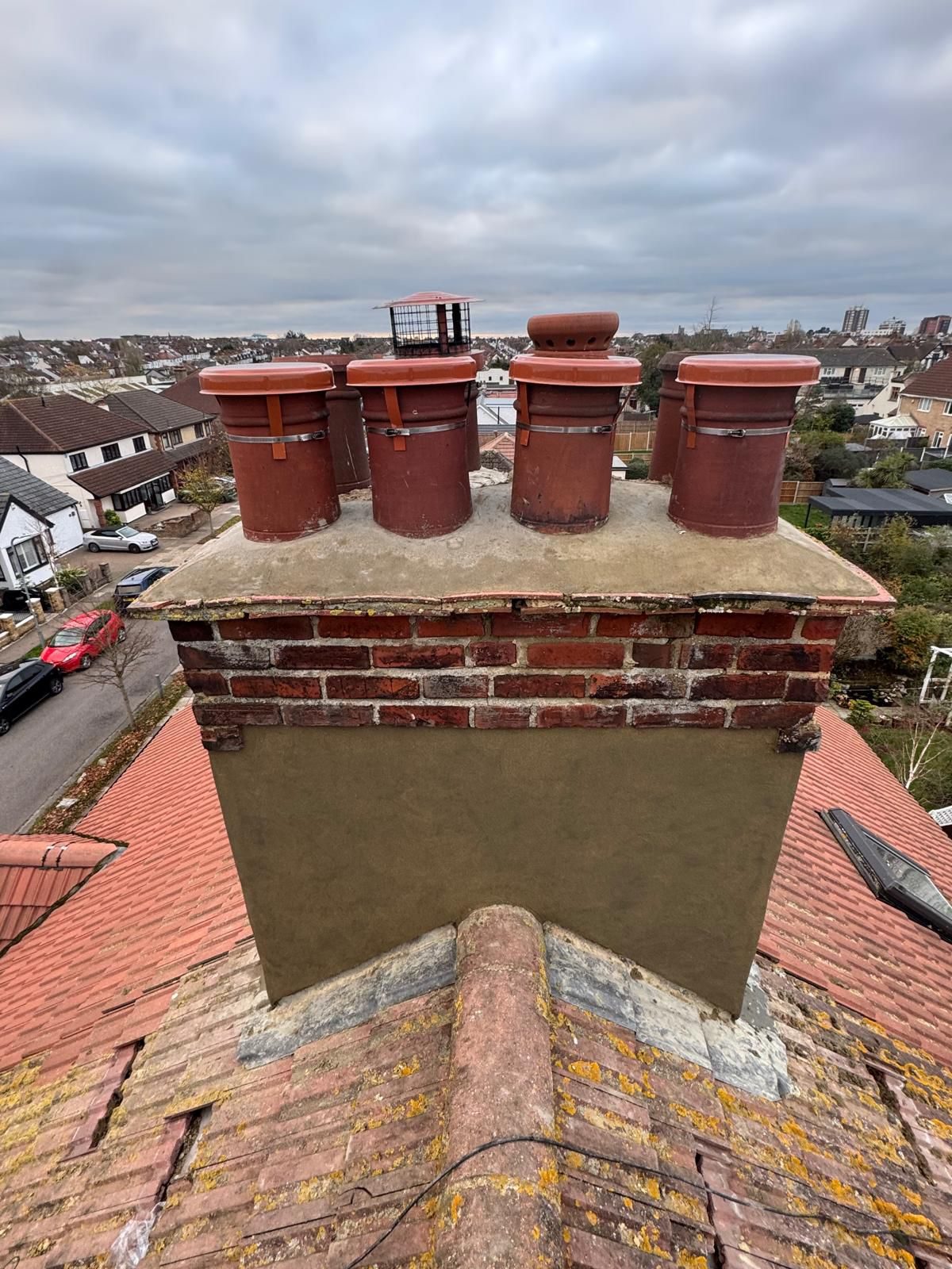 Brick chimney stacks on a freshly tiled roof