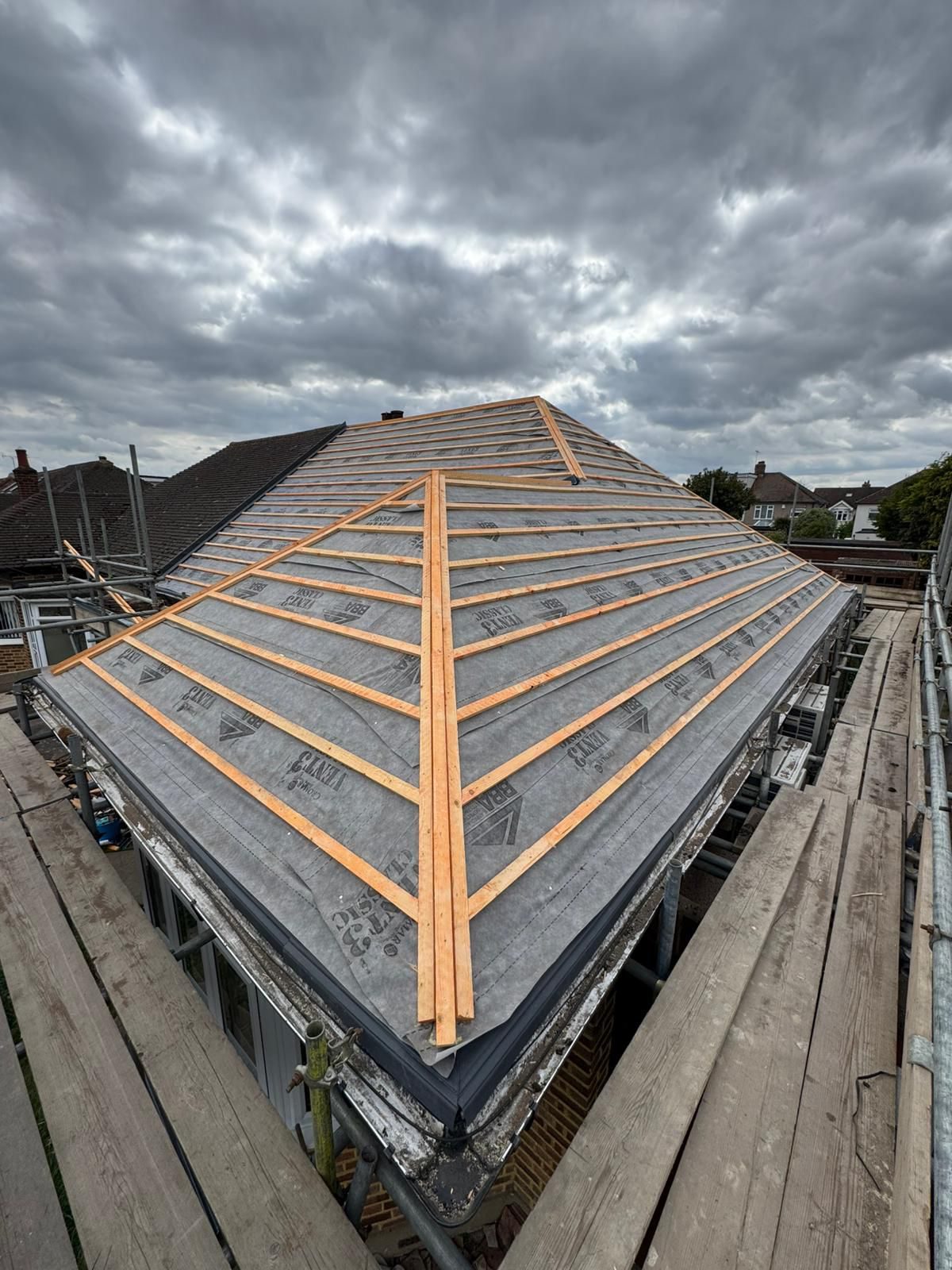 New tiled roof ridge against a dramatic sky